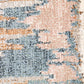 Beige area rug close-up with blue and rust abstract design texture