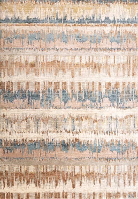Beige area rug close-up with blue and tan abstract distressed pattern