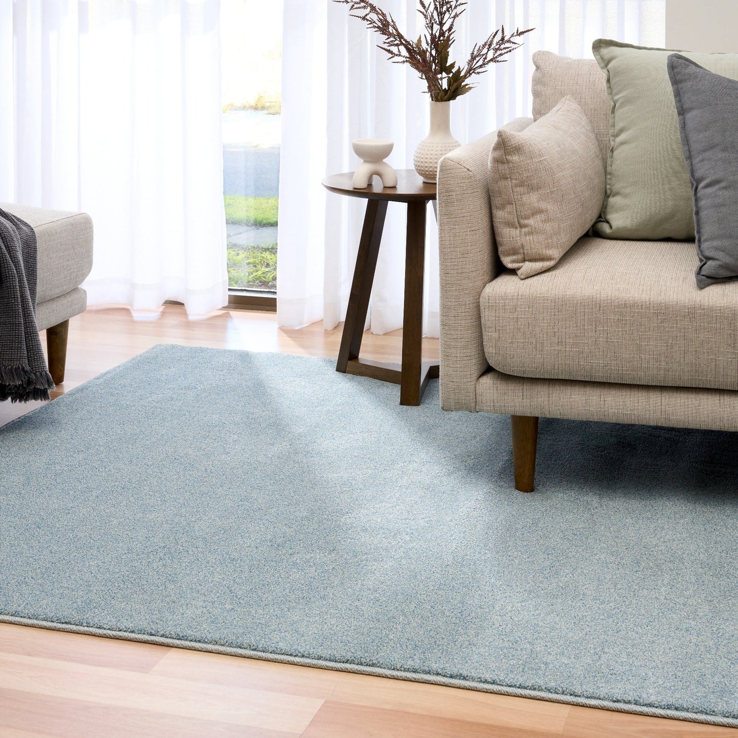 Blue speckled area rug in front of a sofa, rectangular with textured pile. | Eclipse Katana Modern Abstract Polypropylene Area Rug - Rugs Point Australia