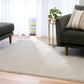 Light gray area rug laid on wood flooring beneath seating. | Eclipse Presidente Modern Polypropylene Area Rug - Rugs Point Australia