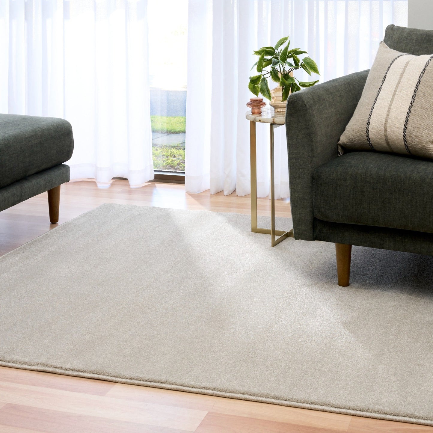 Light gray area rug laid on wood flooring beneath seating. | Eclipse Presidente Modern Polypropylene Area Rug - Rugs Point Australia
