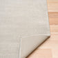 Light gray area rug corner with stitched border and turned-under backing. | Eclipse Presidente Modern Polypropylene Area Rug - Rugs Point Australia