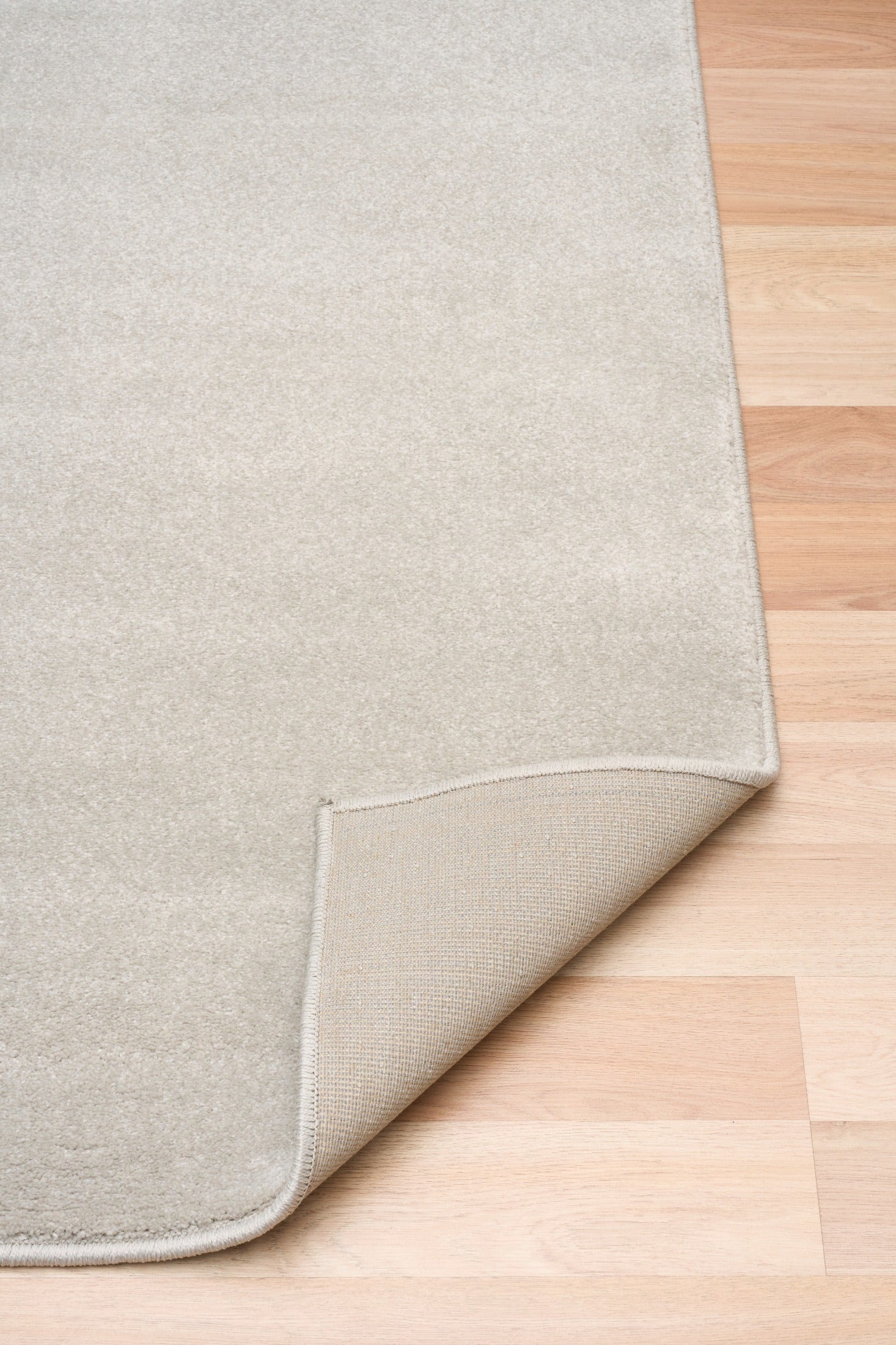 Light gray area rug corner with stitched border and turned-under backing. | Eclipse Presidente Modern Polypropylene Area Rug - Rugs Point Australia