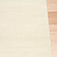 Cream area rug with thin border, corner view on hardwood floor | Eclipse Shanghai White Modern Abstract Floor Rug - Rugs Point Australia