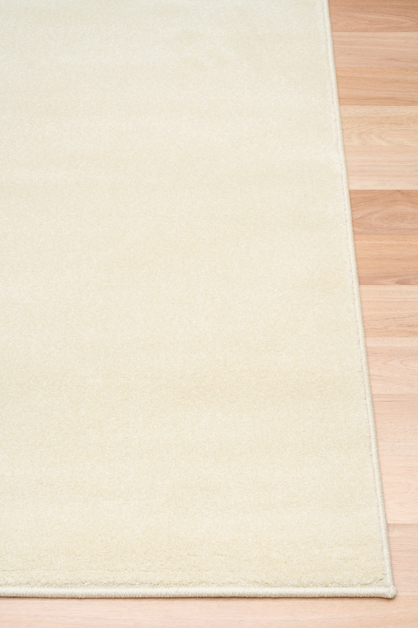 Cream area rug with thin border, corner view on hardwood floor | Eclipse Shanghai White Modern Abstract Floor Rug - Rugs Point Australia