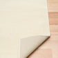 Cream area rug corner with stitched edge and slightly folded backing | Eclipse Shanghai White Modern Abstract Floor Rug - Rugs Point Australia