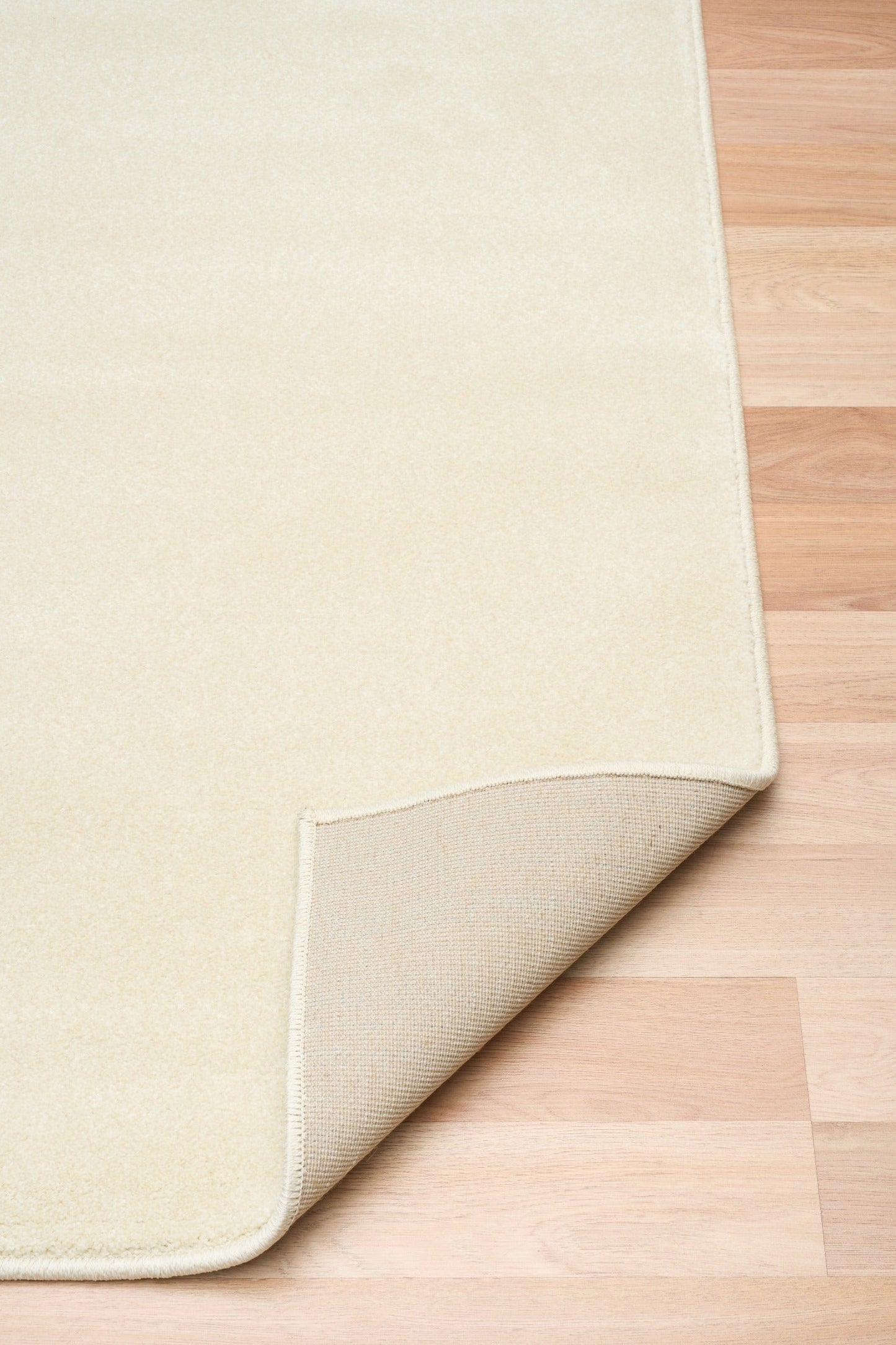 Cream area rug corner with stitched edge and slightly folded backing | Eclipse Shanghai White Modern Abstract Floor Rug - Rugs Point Australia