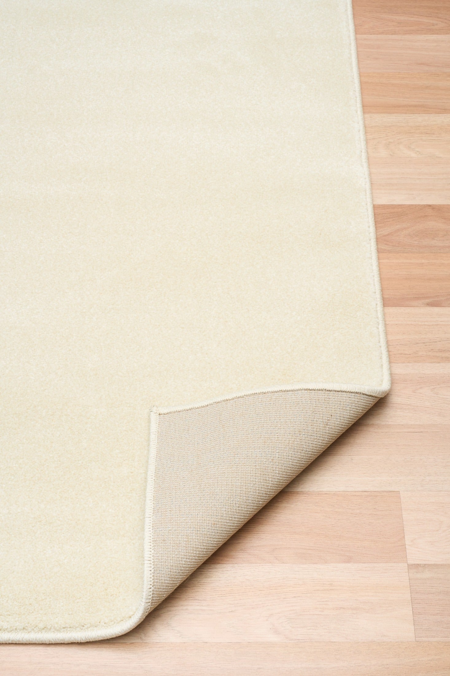 Cream area rug corner with stitched edge and slightly folded backing | Eclipse Shanghai White Modern Abstract Floor Rug - Rugs Point Australia