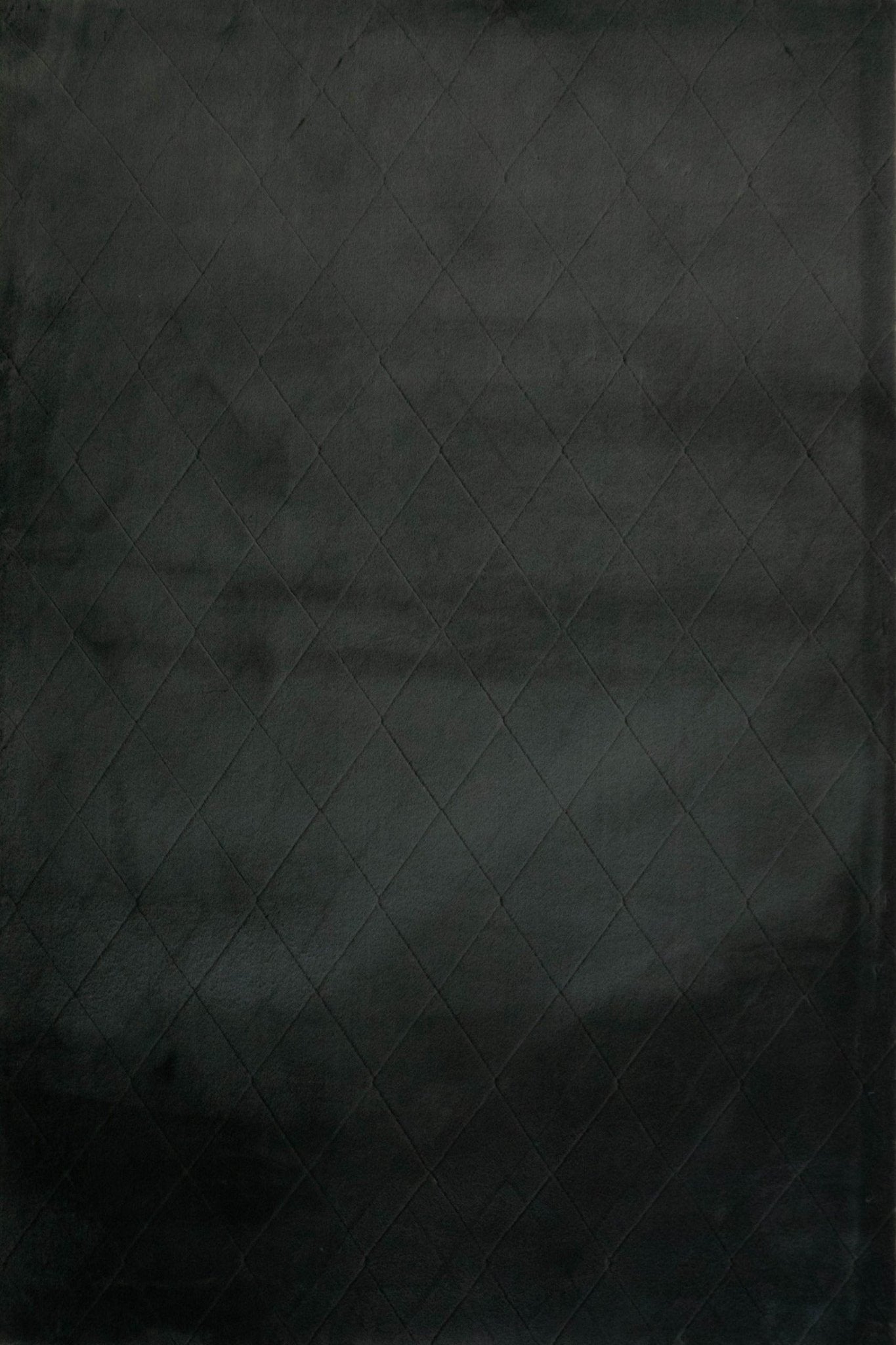 Charcoal rug surface with subtle diamond grid texture