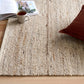 Beige wool rug with looped, textured surface and visible weave pattern