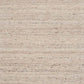 Beige wool rug with subtle speckled texture, close-up of woven fibers