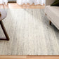 Grey wool area rug full view with textured speckled surface and horizontal bands