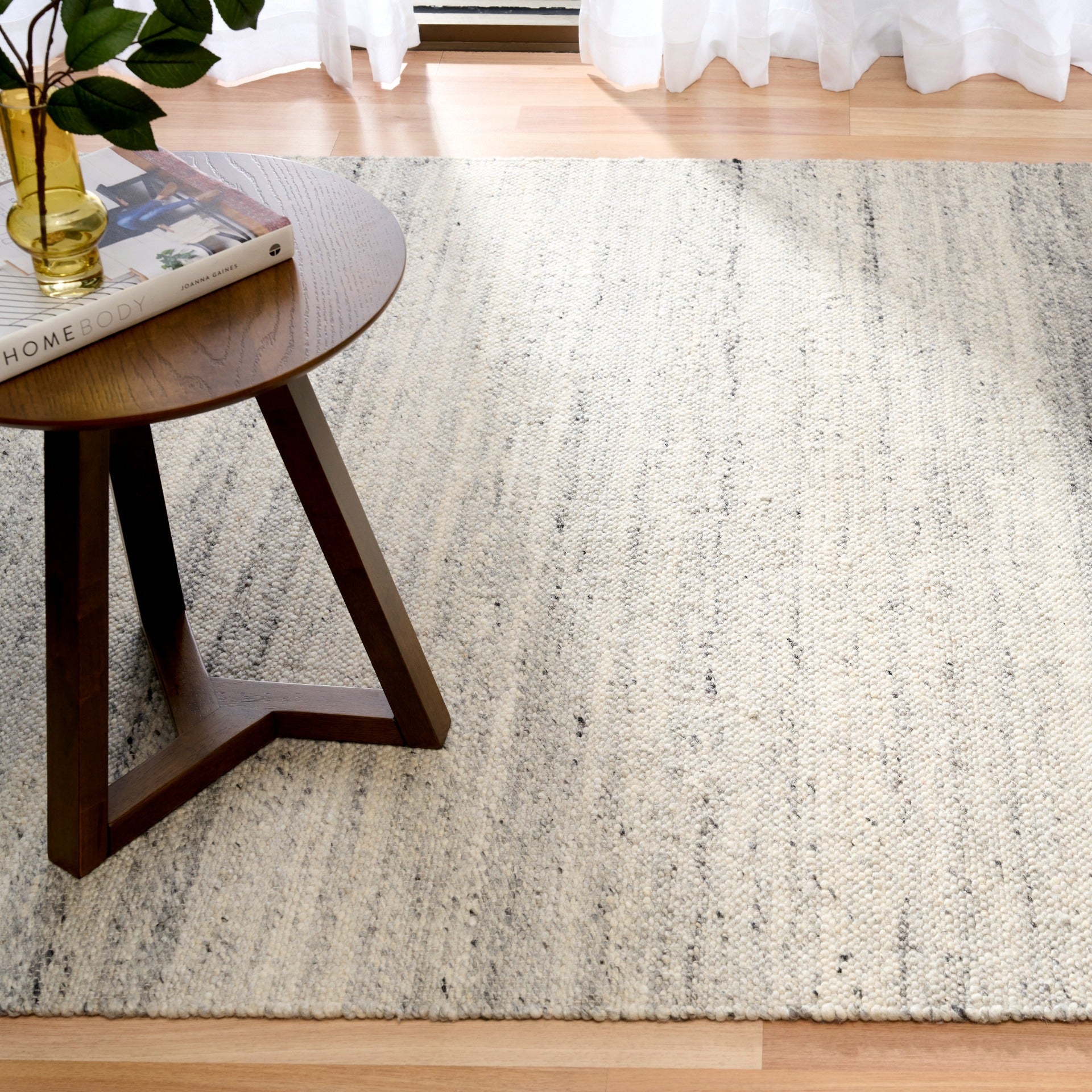 Grey wool area rug full view with speckled texture and thin horizontal striping