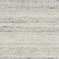 Grey wool rug close-up showing speckles and thin horizontal stitched lines