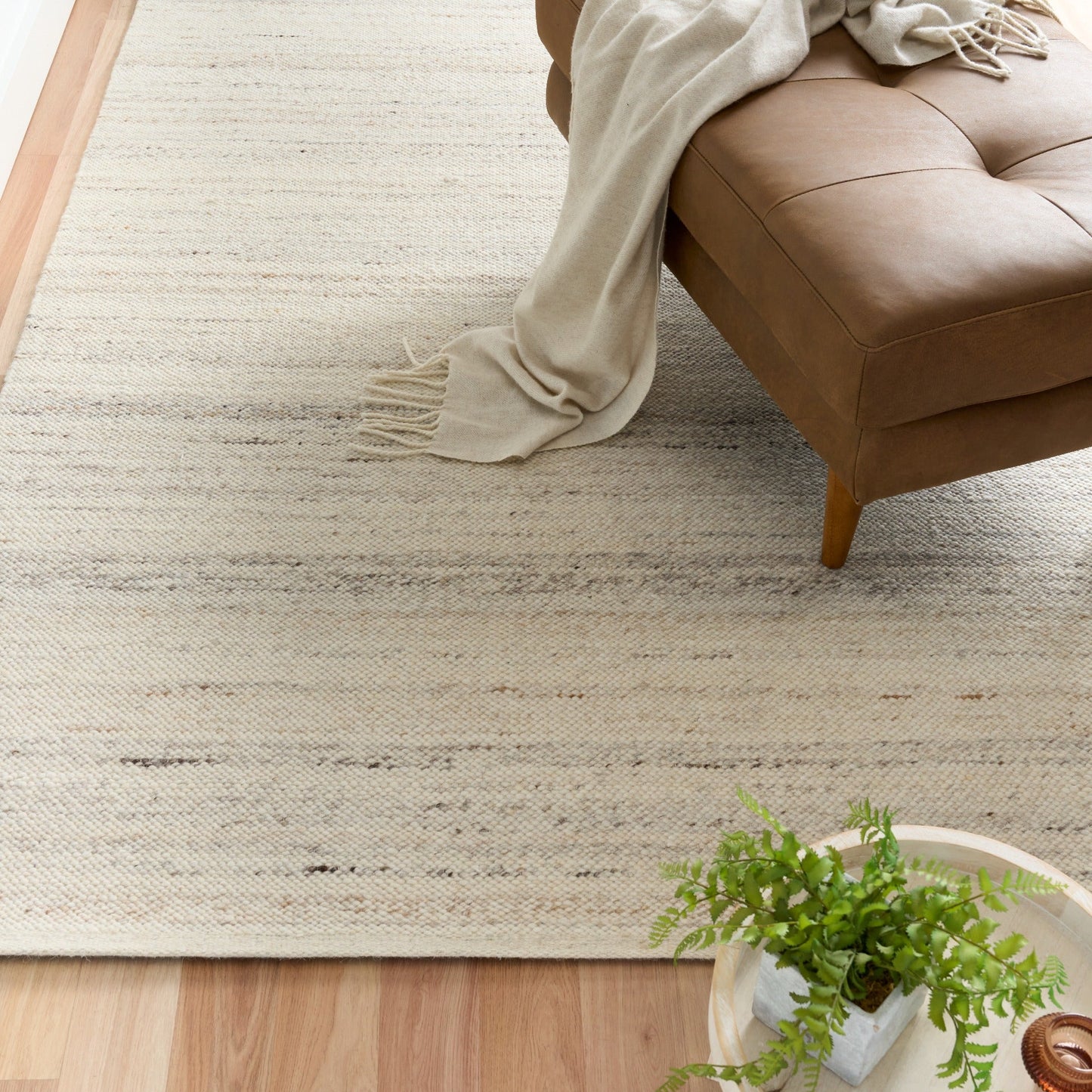 White wool rug with horizontal texture lines and soft, low pile
