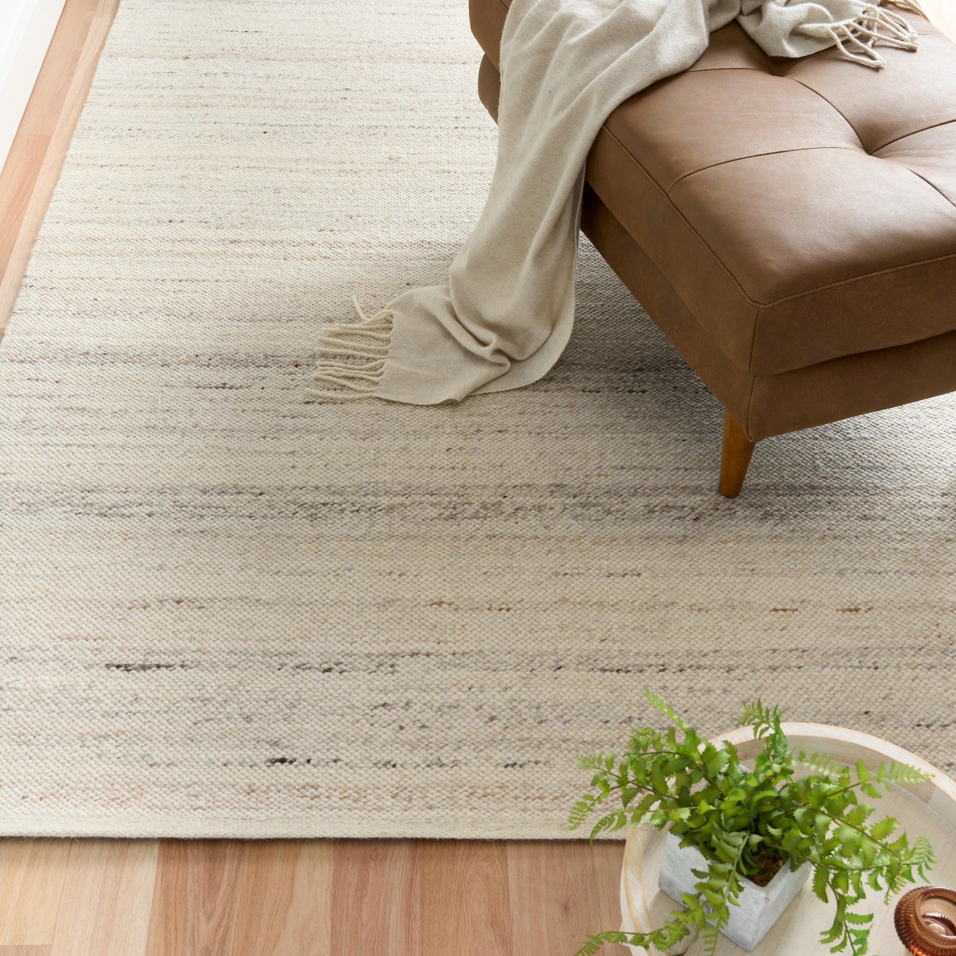 White wool rug with horizontal texture lines and soft, low pile