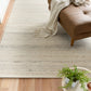 White wool rug with linear weave texture and low, flat pile