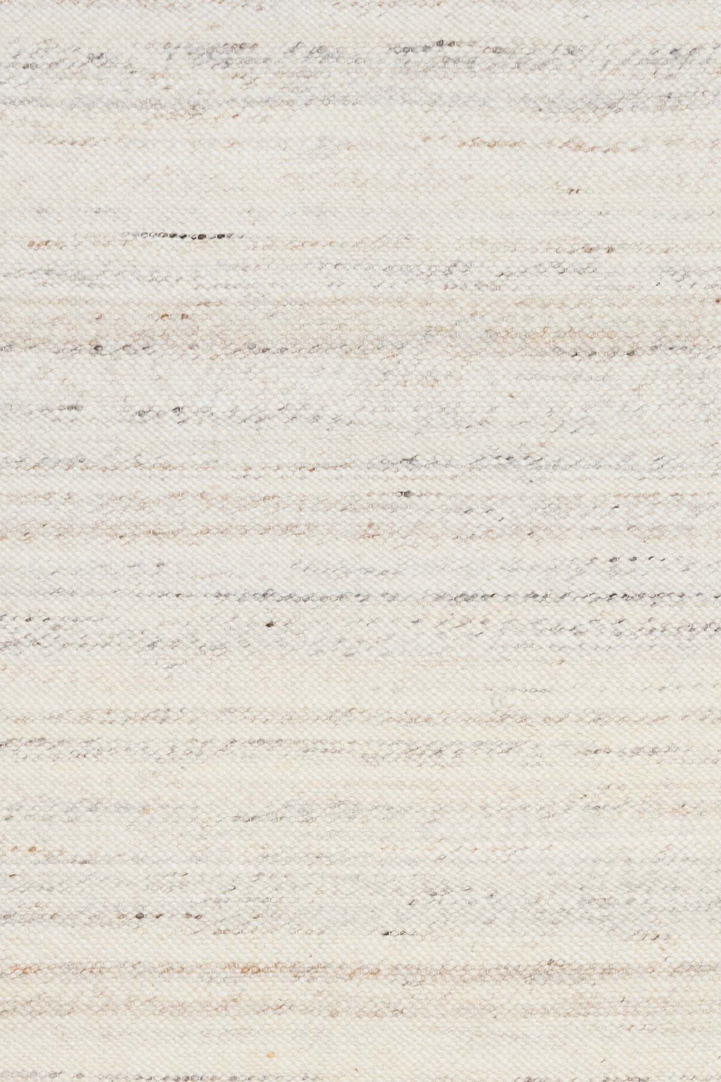 Close-up of white wool rug surface with speckled, woven horizontal pattern