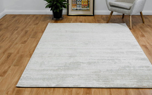 Light beige modern area rug with subtle speckled pattern, flat-woven look