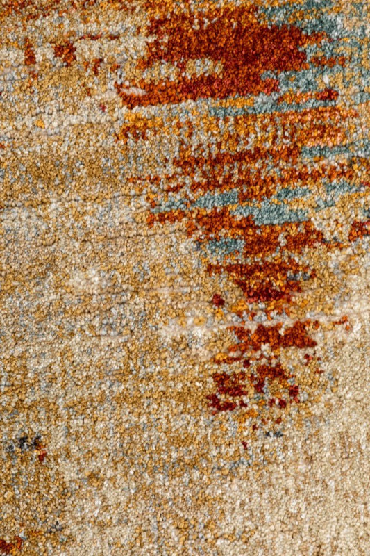 Abstract distressed rug surface in rust and light blue over ivory