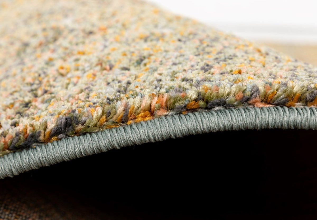 Beige multipurpose rug close-up showing thick pile and gray stitched edge