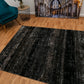 Black abstract area rug with mottled gray pattern, rectangular design