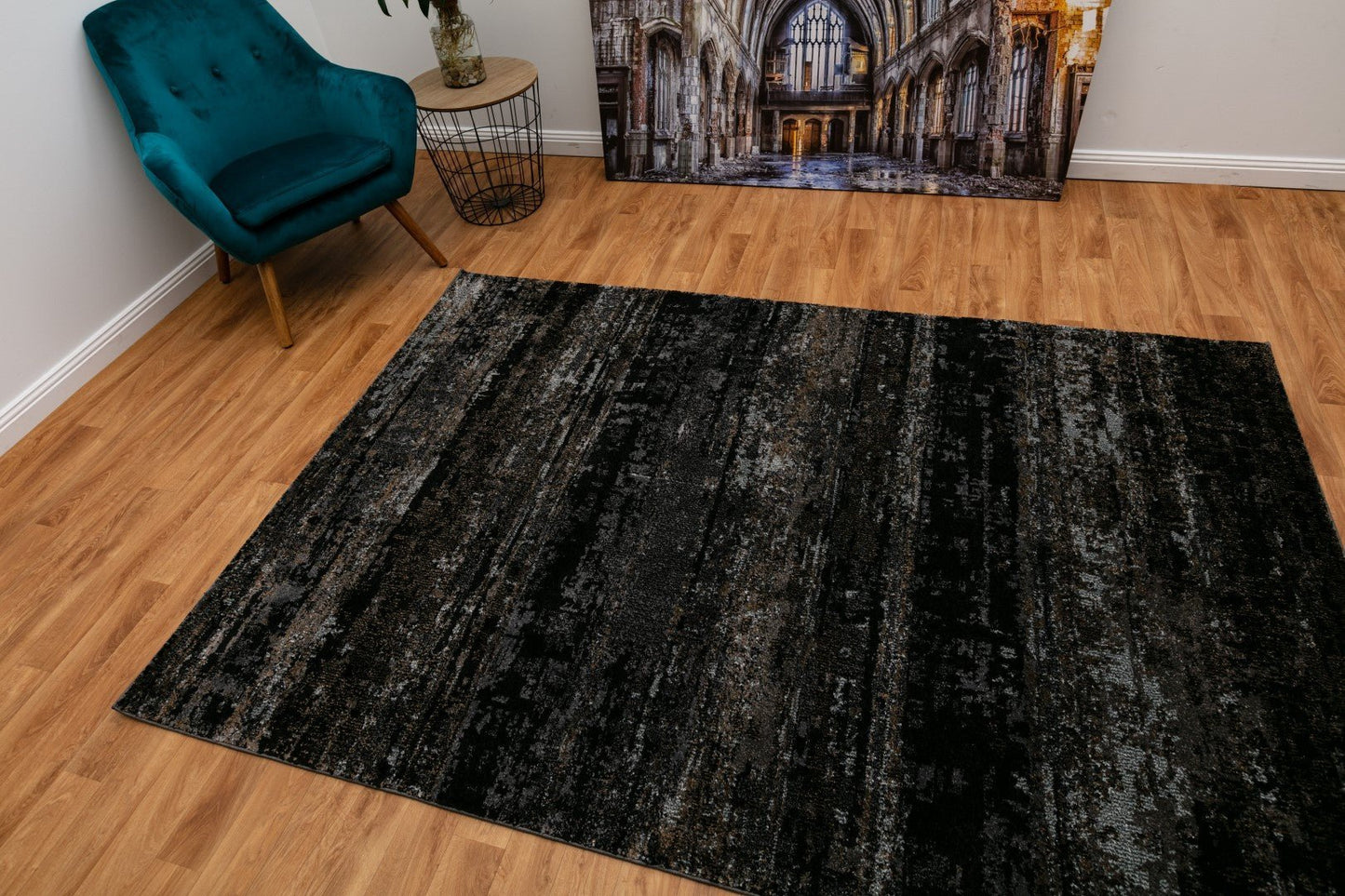 Black abstract area rug with mottled gray pattern, rectangular design
