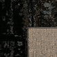 Black area rug corner detail with woven light backing trim