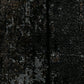 Black area rug close-up with grainy mottled gray speckles