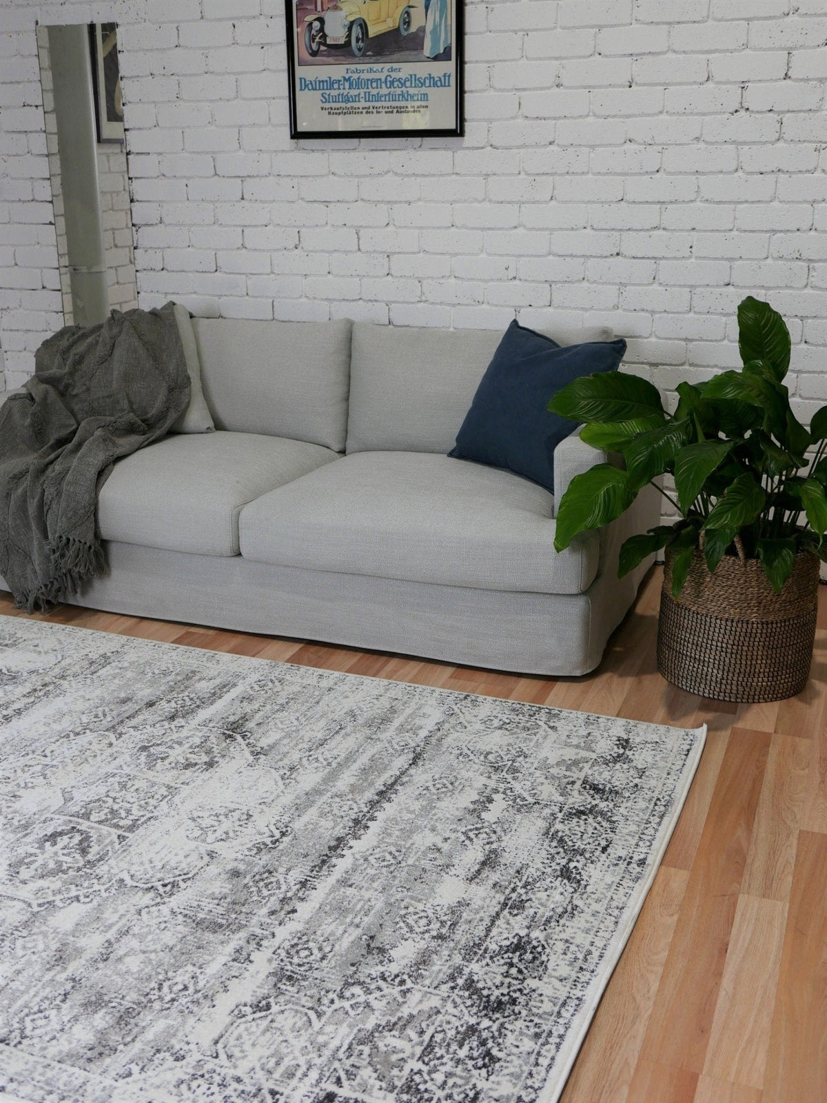 Grey patterned area rug with distressed geometric motif