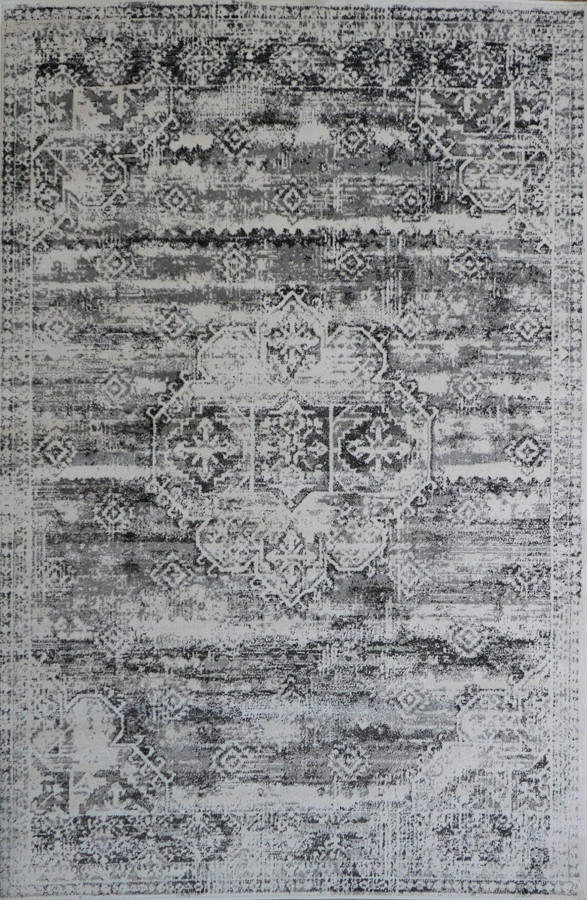 Grey modern area rug with distressed geometric medallion pattern