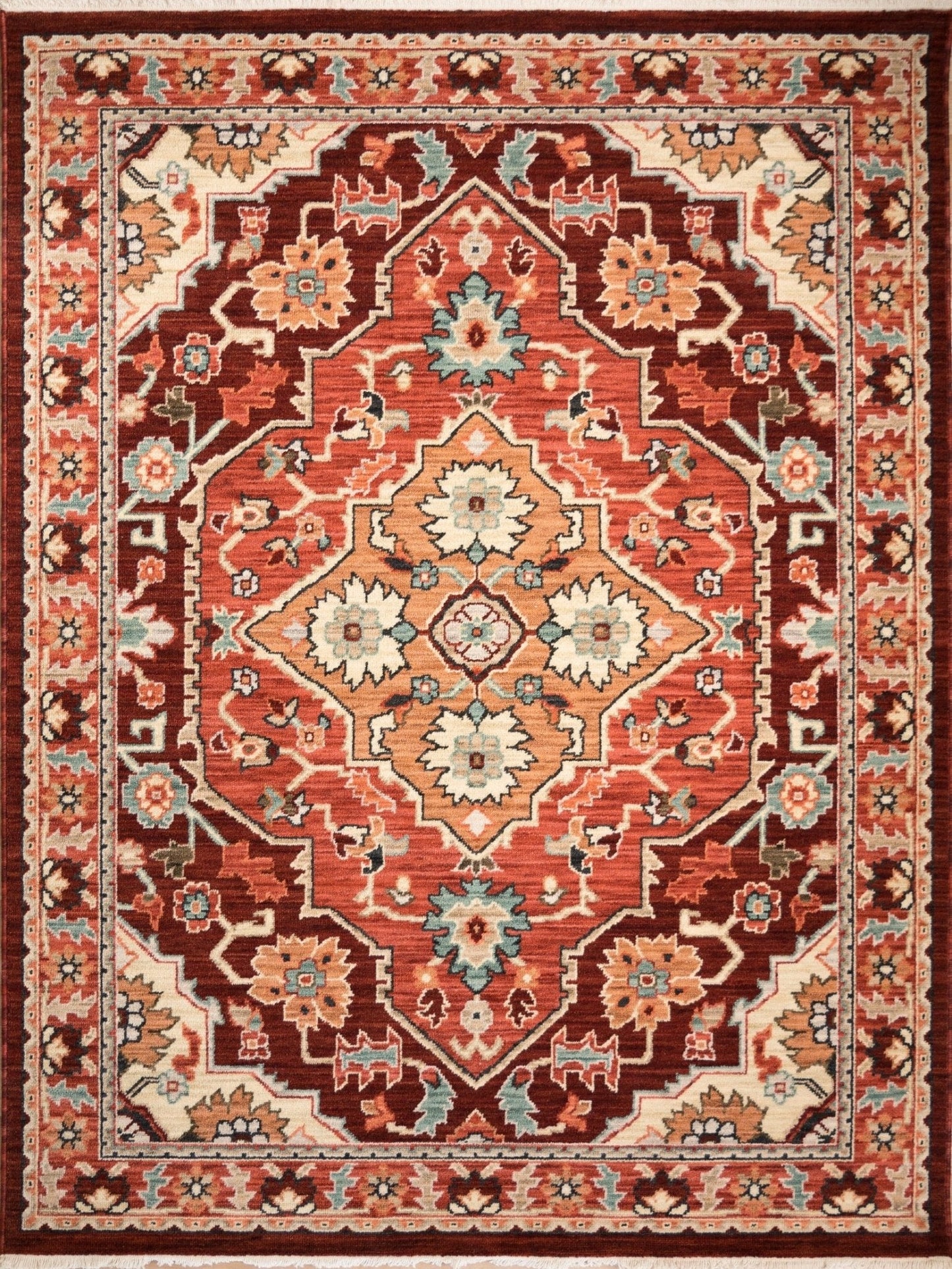 Wool rug with ornate red, cream, and navy floral medallion pattern