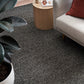 Charcoal textured area rug on hardwood floor