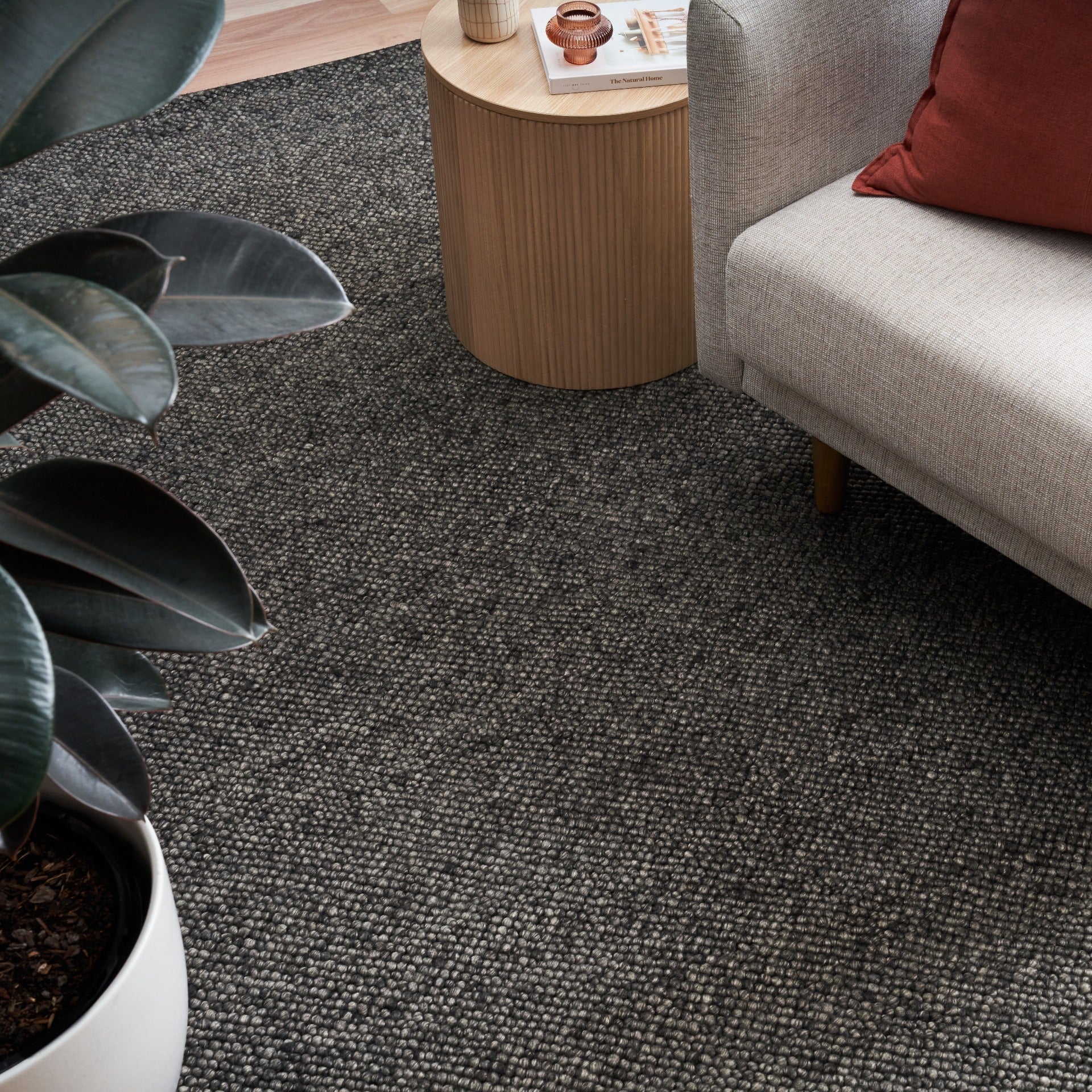 Charcoal textured area rug on hardwood floor