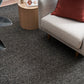 Charcoal textured area rug on hardwood floor