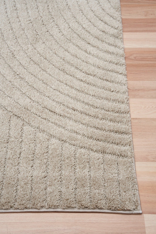 Beige modern rug corner detail with curved stripe lines and stitched border
