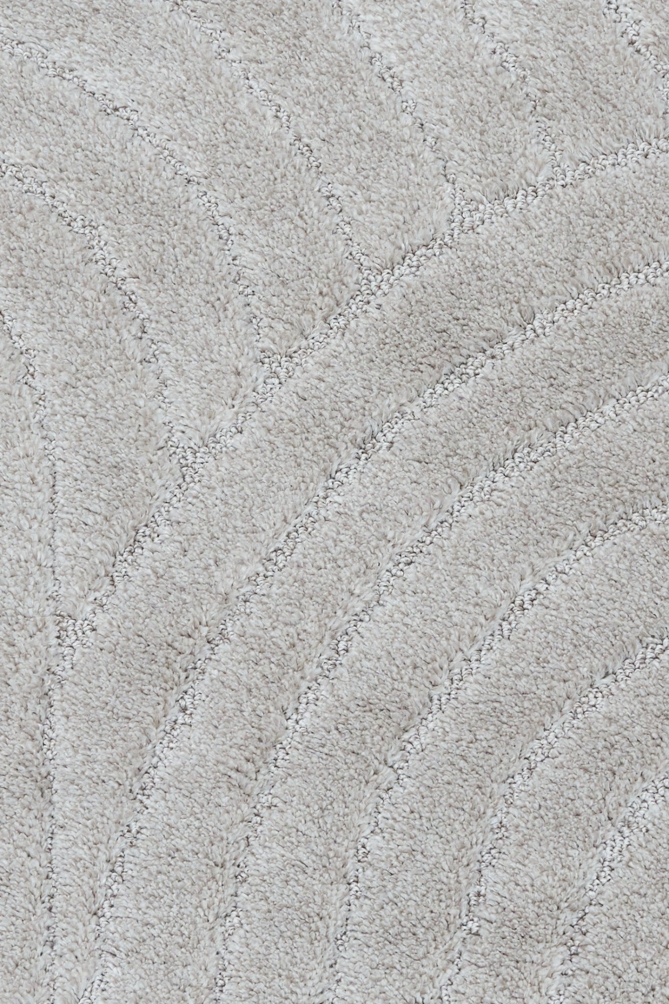 Light grey shag rug with stitched wave pattern and textured pile
