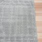 Light grey shag rug with textured surface and subtle speckles, trimmed edge