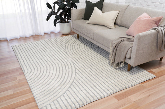 Ivory and light gray area rug with curved wave lines and vertical stripes