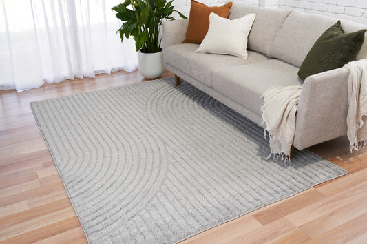 Light grey Turkish rug with curved striped texture, edge visible