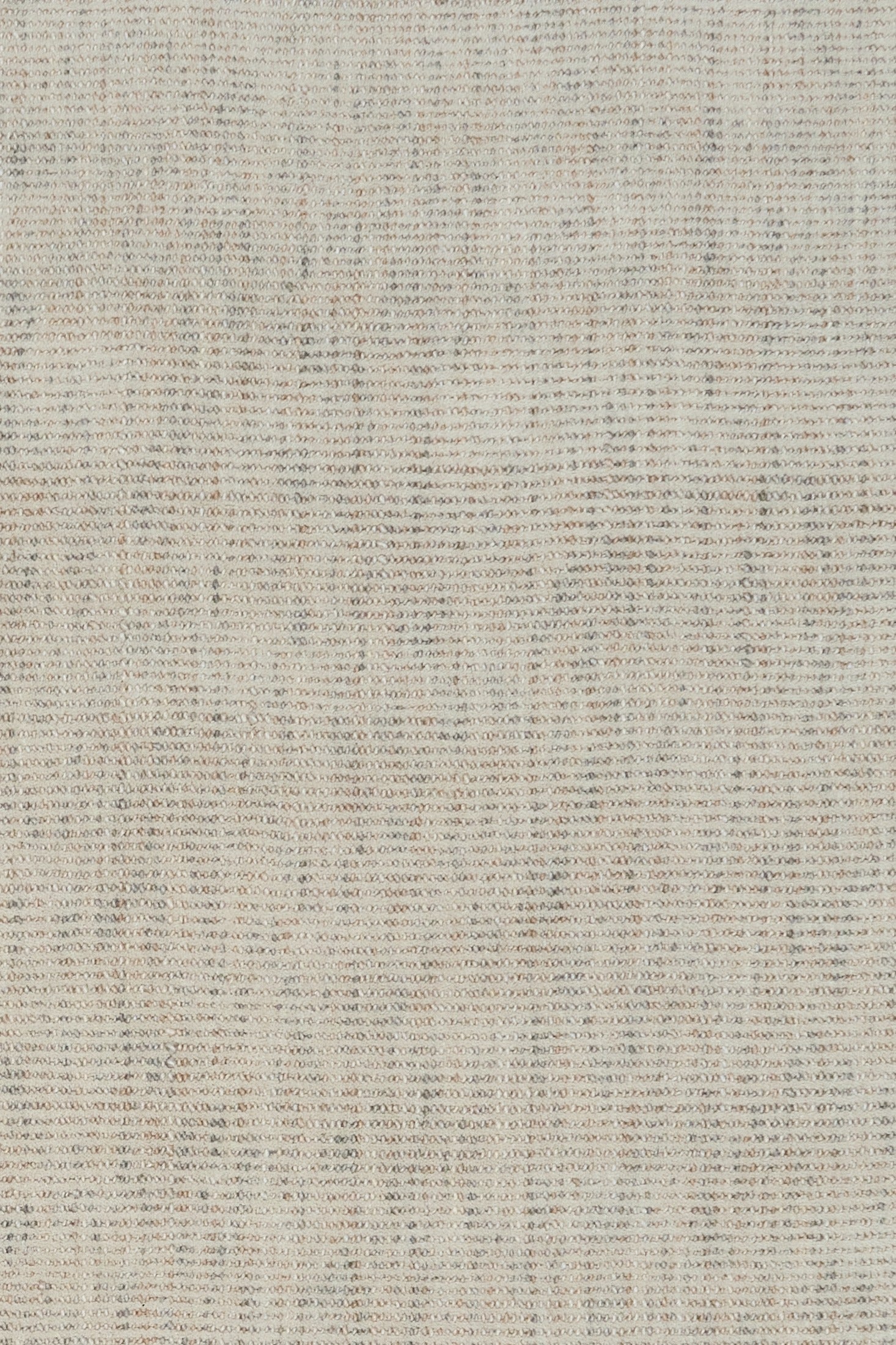 Light gray woven rug surface with tight, speckled textured weave