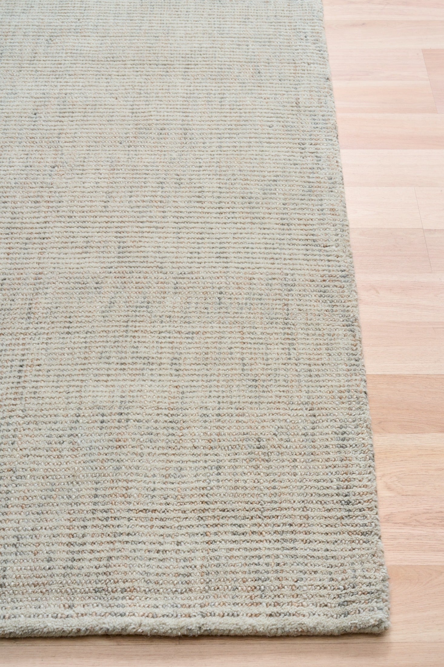Light gray woven area rug with straight hem and square edge
