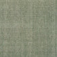 Green textured area rug with tightly woven speckled pattern, close-up view