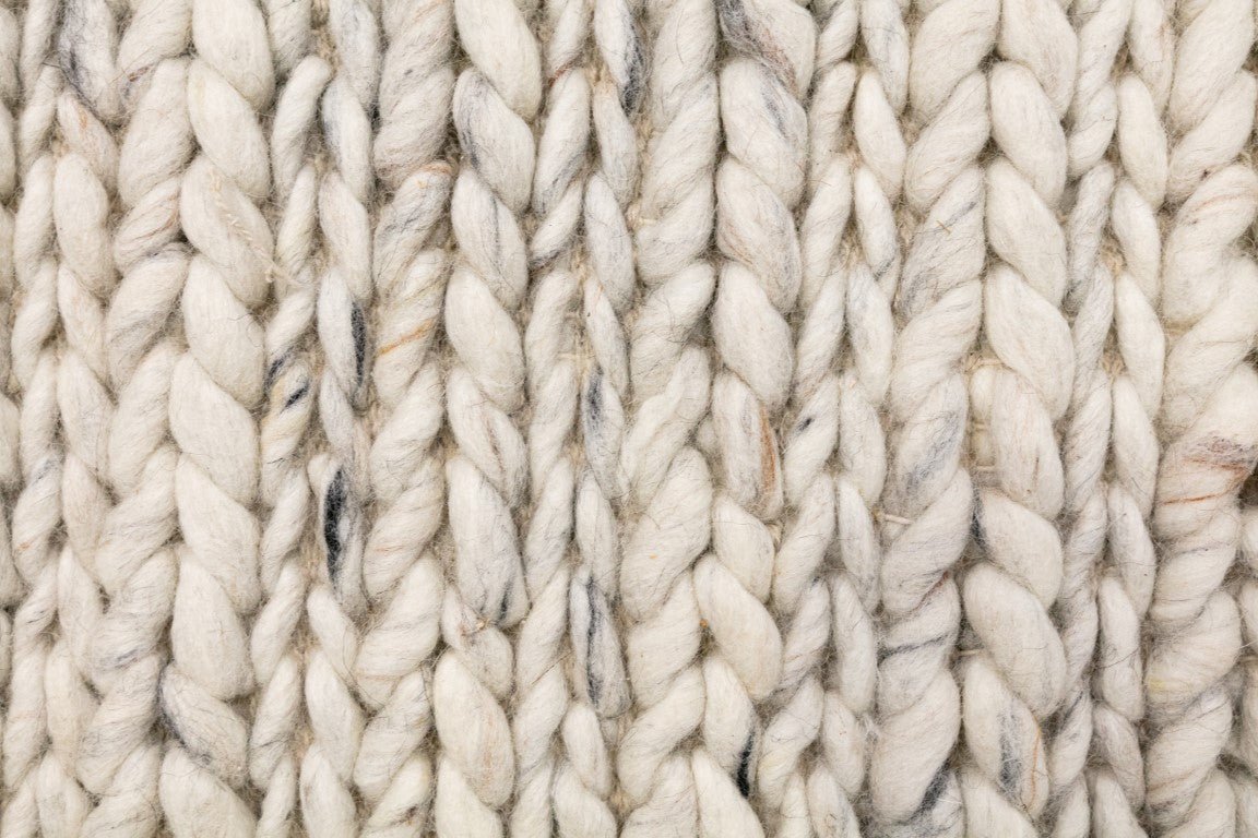 Ivory chunky wool knit rug surface with raised looped ridges