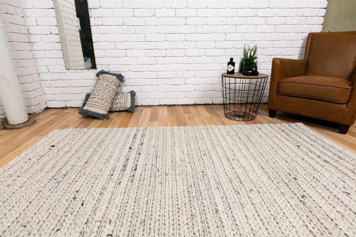 Ivory chunky knit wool floor rug spread flat on the floor