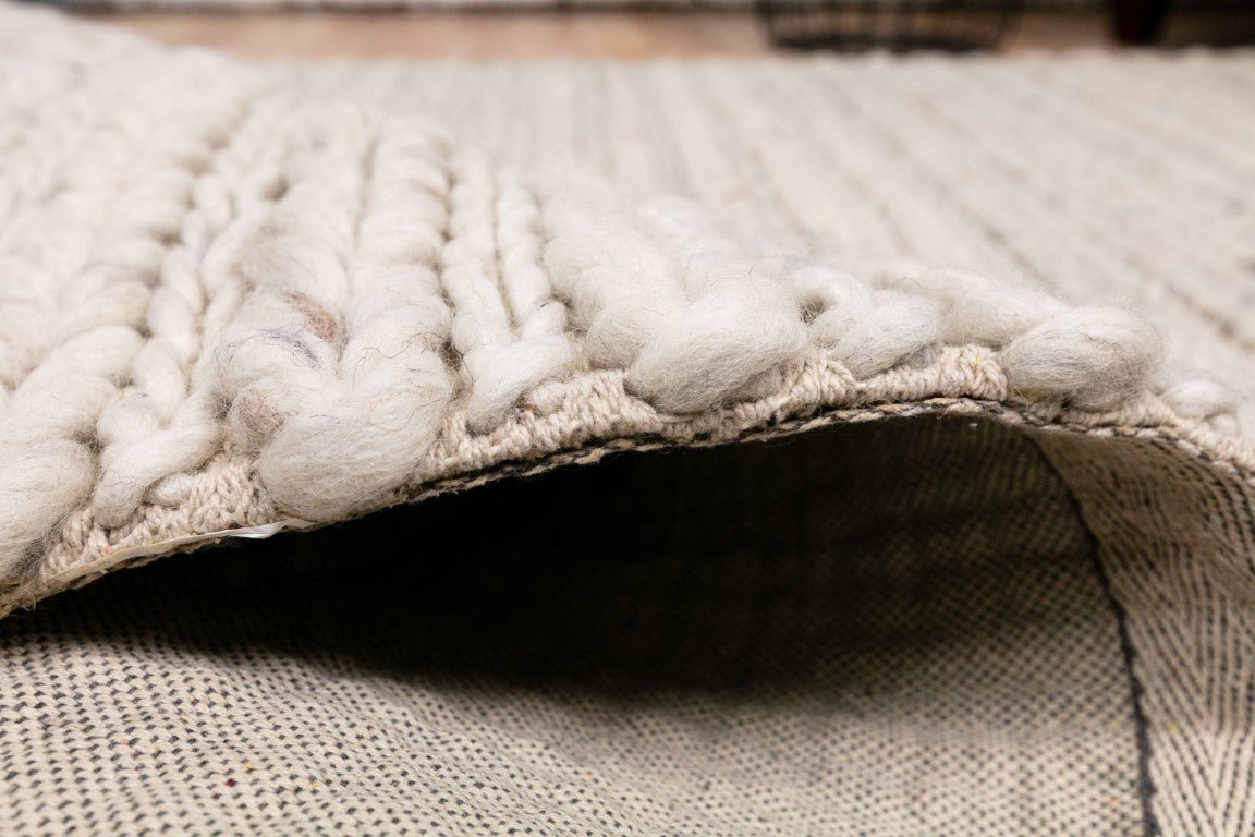 Ivory chunky knit wool rug edge with folded border and thickness