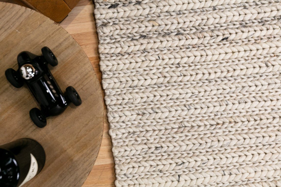 Ivory chunky knit wool floor rug with ribbed texture and thick pile
