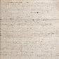 Light neutral wool rug with tight woven texture and subtle speckled flecks