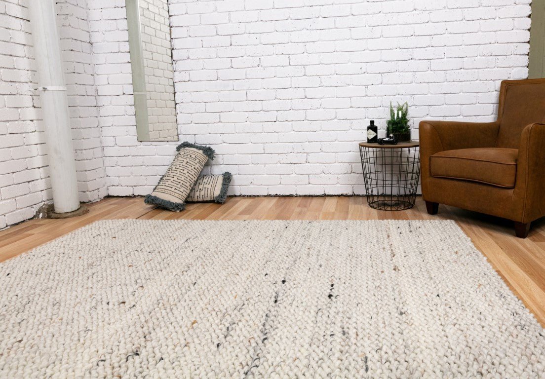 Luxury wool rug in light neutral, chunky loop-knit texture with dense pile