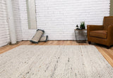 Luxury wool rug in light neutral, chunky loop-knit texture with dense pile